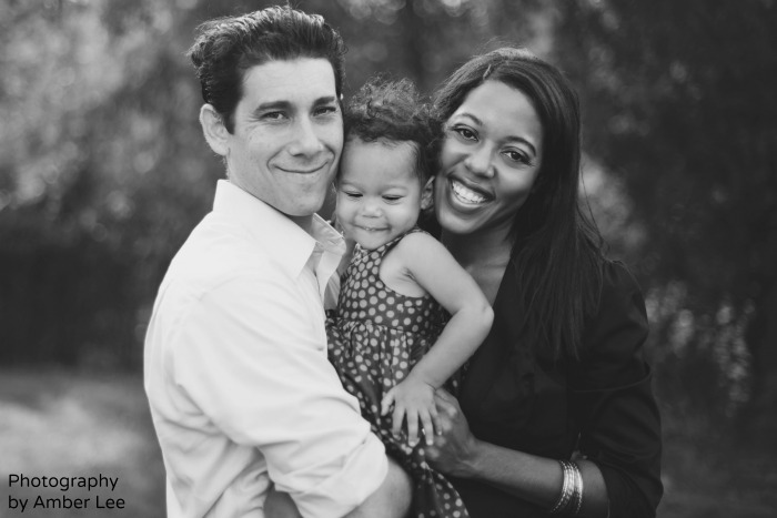 Dee Patience with her husband and their young daughter Jolie, outdoors.